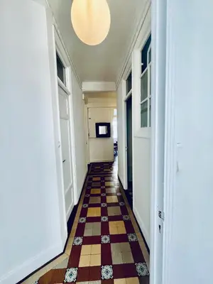 a hallway with a checkered floor and a ceiling at Berlioz Nath in Nice