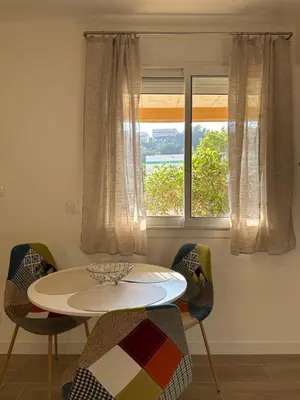 a table and chairs in a room with a window at Studio - Nice Palais des Expositions in Nice