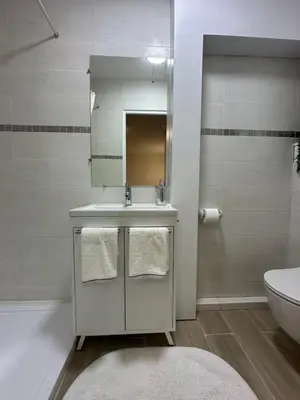 a bathroom with a sink and a mirror and a toilet at Studio - Nice Palais des Expositions in Nice