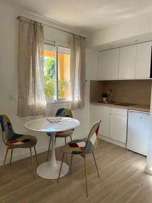a kitchen with a white table and chairs and a table at Studio - Nice Palais des Expositions in Nice