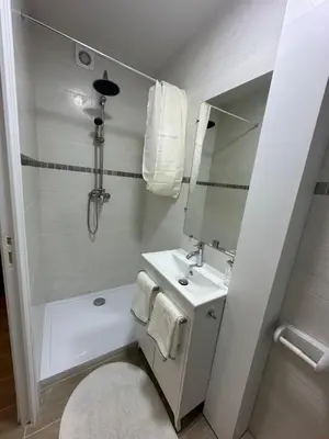 a bathroom with a shower and a sink and a mirror at Studio - Nice Palais des Expositions in Nice
