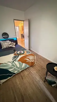 a bedroom with a bed with a painting on it at Appartement elegant a Nice in Nice