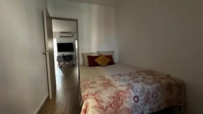 a bedroom with a bed and a door to a room at Appartement elegant a Nice in Nice