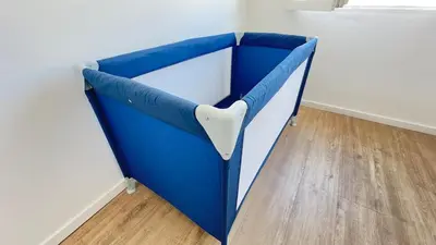 a blue and white chair in a corner of a room at Appartement elegant a Nice in Nice