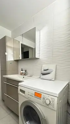 a kitchen with a washing machine and a sink at Appartement elegant a Nice in Nice
