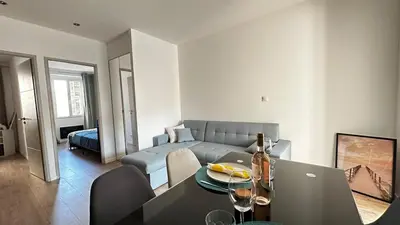 a living room with a couch and a table with a laptop at Appartement elegant a Nice in Nice