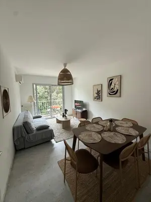 a living room with a couch and a table at Appartement 3p proche mer in Nice