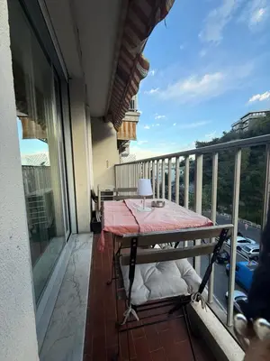two beds in a room with a large window at Appartement 3p proche mer in Nice