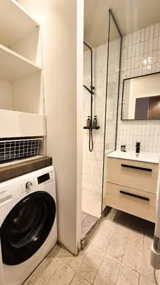 a washing machine in a bathroom with a shower at Grand studio cosy au cœur du Vieux-Nice in Nice