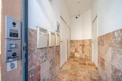 a room with a tile hallway with a washer and dryer at Charmant studio cosy - Nice Est in Nice