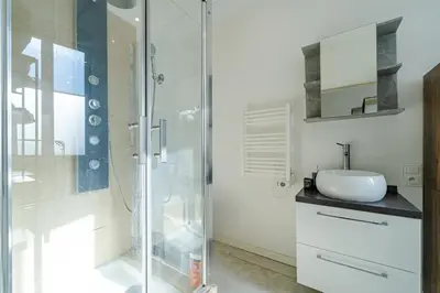 a bathroom with a glass shower and a sink at Charmant studio cosy - Nice Est in Nice