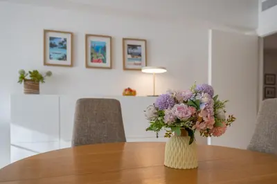 a vase filled with flowers sitting on top of a table at flora in Beaulieu-sur-Mer