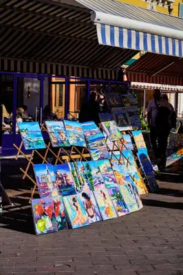 a group of books on display on a sidewalk at La Verrière du Vieux Nice in Nice