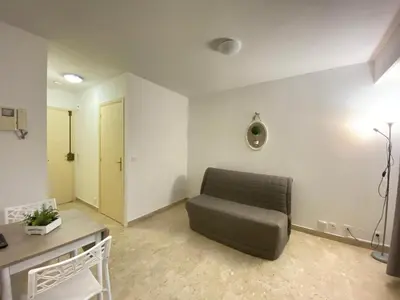a living room with a couch and a table at Emanuela in Nice