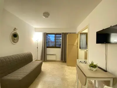 a living room with a couch and a table at Emanuela in Nice