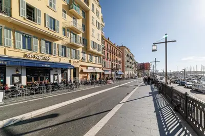 a city street with buildings and people walking down the street at MY CASA - EMMANUEL - Cozy apartment with Port view in Nice