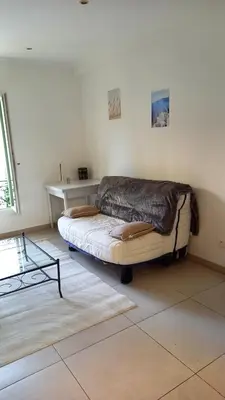 a room with a bed with a table in it at Villa Cornetti in Nice