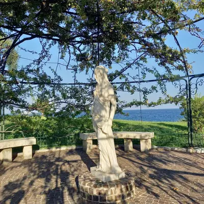 a statue of a man sitting on a bench at Villa Cornetti in Nice