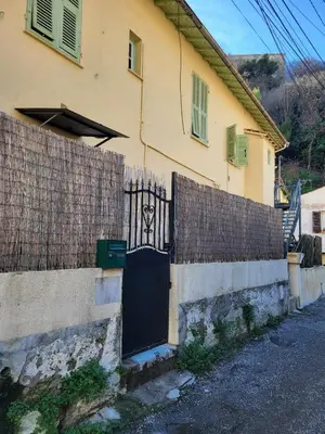 a house with a black gate and a fence at Villa Cornetti in Nice