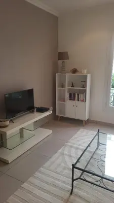 a living room with a flat screen tv on a table at Villa Cornetti in Nice