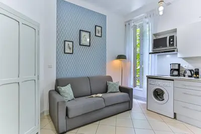 a living room with a couch and a washing machine at GROSSO 1 MD - New 3 minutes from the Sea in Nice