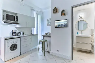 a white laundry room with a washer and dryer at GROSSO 1 MD - New 3 minutes from the Sea in Nice