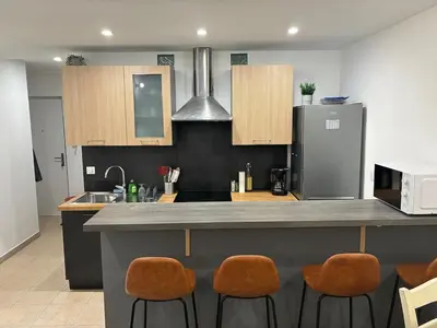 a kitchen with an open door to a room at Cozy 50 m2 - Balcony & Air Conditioning! Heart of Old Nice in Nice