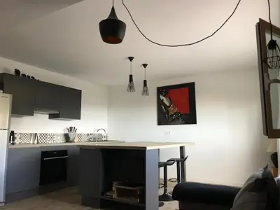 a kitchen with a counter and a table in a room at Villa Muse in Villefranche-sur-Mer