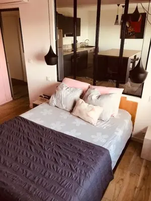 a bedroom with a bed with two pillows on it at Villa Muse in Villefranche-sur-Mer