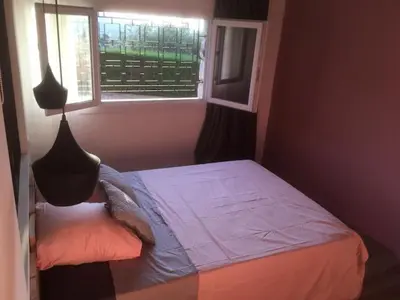 a small bedroom with a bed with a window at Villa Muse in Villefranche-sur-Mer