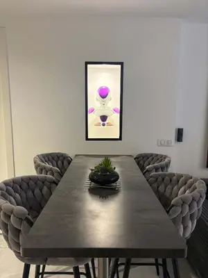 a dining room table with chairs and a painting at T4 Front de mer Piscine interieure privee Clim in Cagnes-sur-Mer