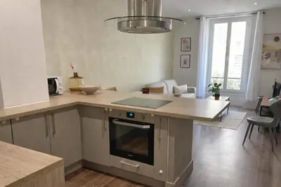 a kitchen with a island with a counter top at RAIMBALDI Urban Gare - Spacieux T3 climatisé au cœur du centre-ville in Nice