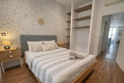 a bedroom with a large bed in a room at RAIMBALDI Urban Gare - Spacieux T3 climatisé au cœur du centre-ville in Nice