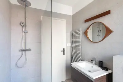 a bathroom with a shower and a sink and a mirror at 10 Félix Faure, Nice in Nice