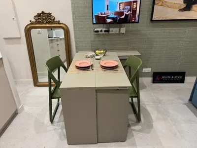 a dining room table with green chairs and a mirror at 10 Félix Faure, Nice in Nice