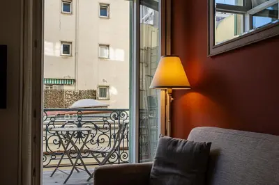 a lamp sitting next to a window with a view of a balcony at L'Écrin de la Piétonne in Nice