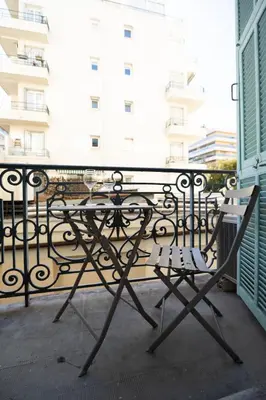 a table and chairs sitting on a balcony at L'Écrin de la Piétonne in Nice