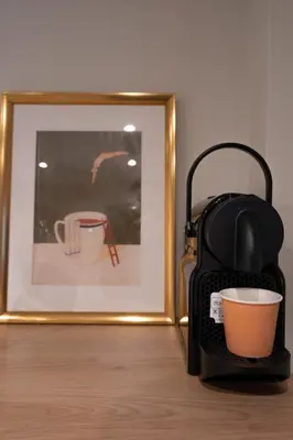 a picture of a cup and a suitcase next to a picture at L'Écrin de la Piétonne in Nice