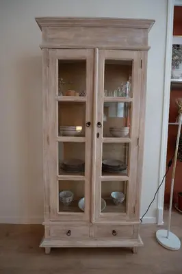 a wooden cabinet with plates and dishes in it at L'Écrin de la Piétonne in Nice