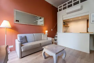 a living room with a couch and a table at L'Écrin de la Piétonne in Nice
