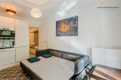 a living room with a bed and a kitchen at Nice 2 pièces proche centre in Nice