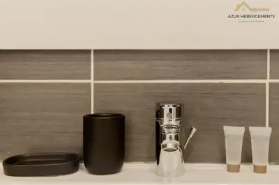 a counter top with a blow dryer and a container at Nice 2 pièces proche centre in Nice