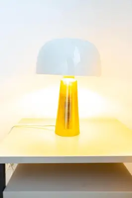 a yellow lamp sitting on top of a table at Rue Michelet in Nice