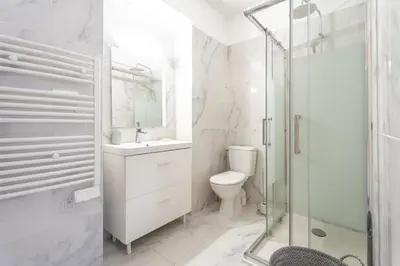 a bathroom with a toilet and a glass shower at Rue Michelet in Nice