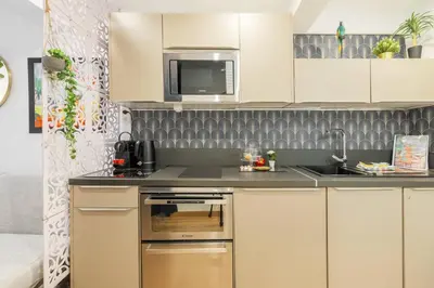 a kitchen with a sink and a microwave at 9 rue Pairoliere in Nice
