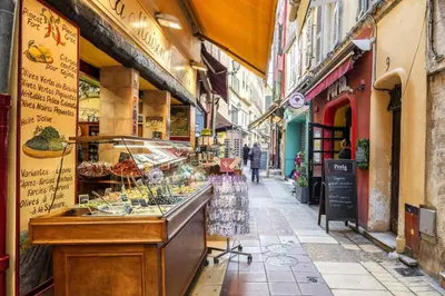 a street with a food stand in an alley at 9 rue Pairoliere in Nice