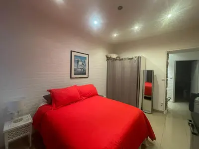 a bedroom with a red bed in a room at One-Bedroom Apartment near Promenade des Anglais in Nice