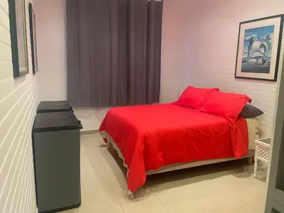 a bedroom with a bed with a red blanket at One-Bedroom Apartment near Promenade des Anglais in Nice