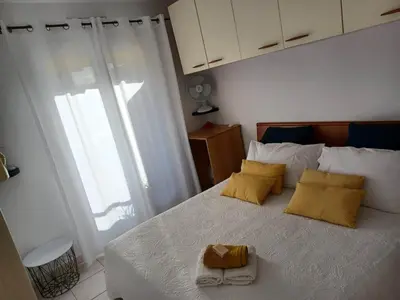 a bedroom with a bed with two yellow pillows at L'escale à la French Riviera in Nice