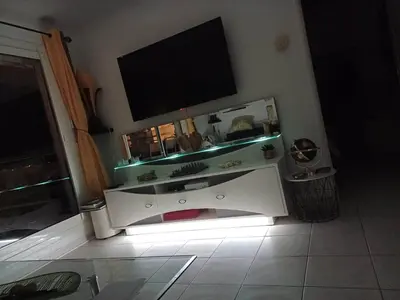 a white entertainment center with a flat screen tv on top at L'escale à la French Riviera in Nice